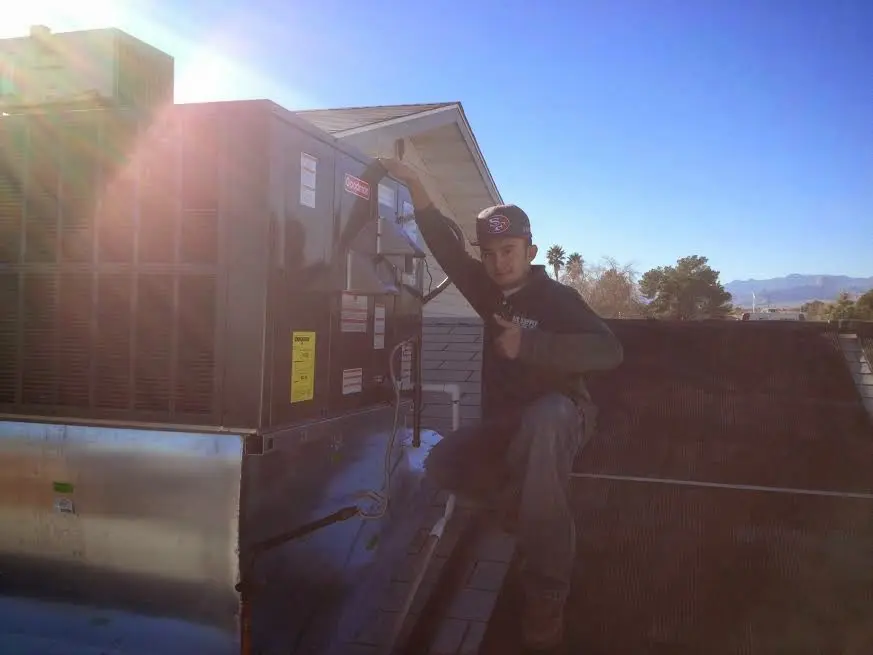 HVAC technician performing Air Duct Repair on a rooftop unit in Mount Pleasant